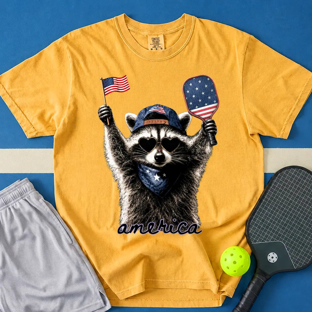May include Feral & Pickleball T-Shirt in mustard t-shirt with Feral & Free Raccoon design