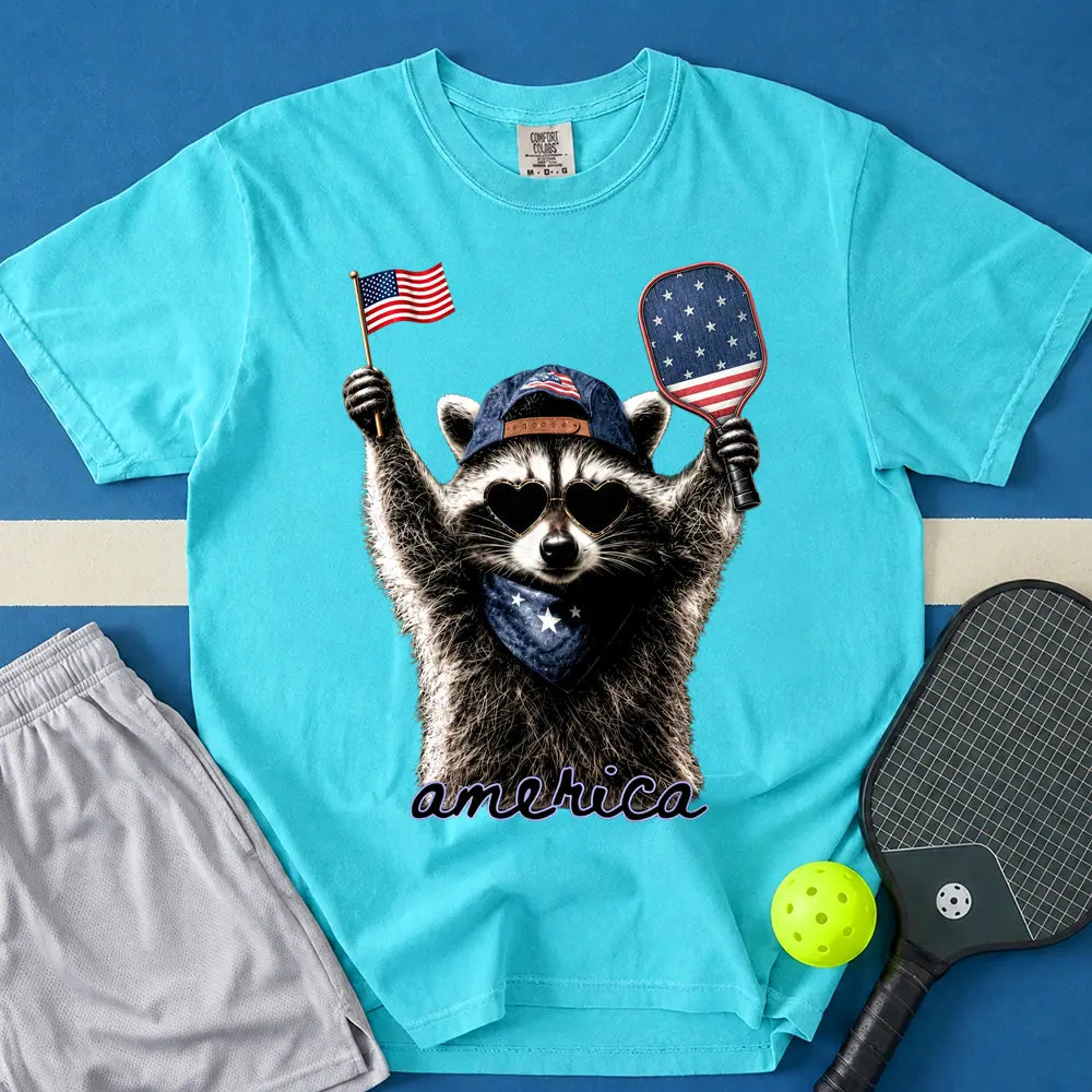 May include Feral & Pickleball T-Shirt in lagoon t-shirt with Feral & Free Raccoon design
