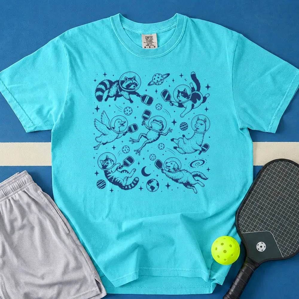 May include Space Pickleball T-Shirt in lagoon t-shirt with Space Pickleball design
